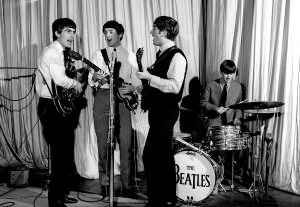 Photo of The Beatles playing on stage as shown on the Reeves Motal Piano and Synthesizer Music Website